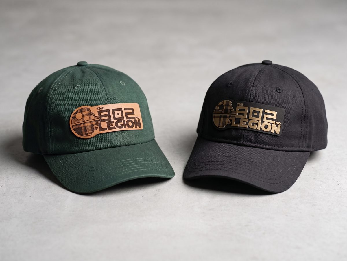 Two baseball caps — forest green and black — each with a laser-engraved leather patch reading "The 802nd Legion" in a Star Wars-style logo.